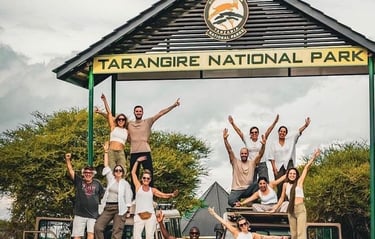 Group photo of tourists at the main entrance of Tarangire National Park in Tanzania before starting a safari adventure