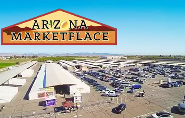 Aerial view of the Arizona Marketplace outdoor flea market with rows of tents and a large parking lot.