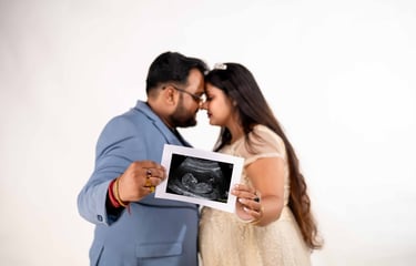 Husband and wife celebrating pregnancy during indoor maternity session