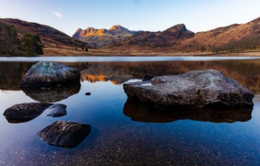 Scenic view of the Langdale Pikes reflected in the calm waters of Blea Tarn, Lake District.