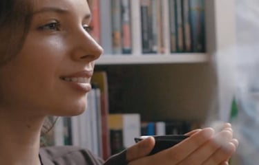 a woman holding a tea in her hand
