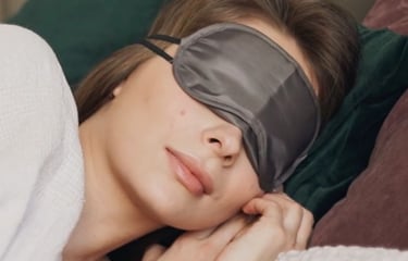 woman sleeping with eye covers