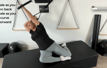 a woman extended backwards with a suspension trainer