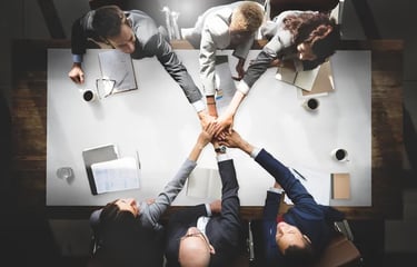 a group of people holding hands in a circle martin pe coach
