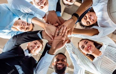 a group of business people standing in a circle with their hands together martin pe coach