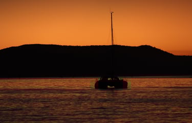 a boat in the water at sunset