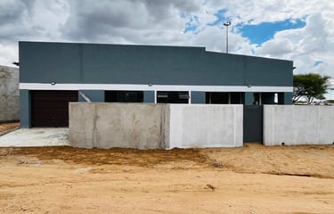 a building with a garage door and a garage door, House Construction Frans-del Investment CC Construc