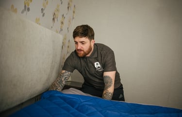 deanos removals worker covering a bed