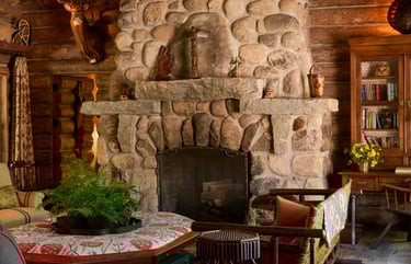 Sienna Miller's rustic stone fireplace in her home.