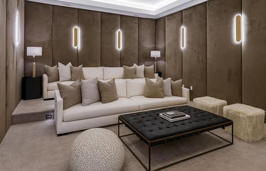 Luxurious home theater with custom wall panels, plush sofa, modern lighting, and stylish coffee table by Solo Home Decor.