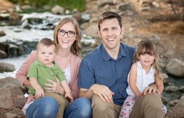 Family sitting together outdoors for a natural family portrait session in Gilbert, Arizona.