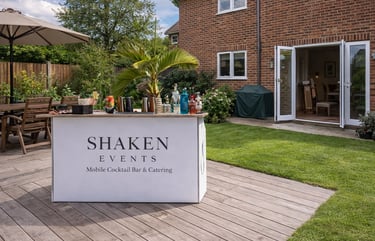 Shaken Events mobile cocktail bar and catering setup on a backyard patio for a private garden party.