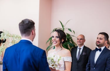 a bride and groomsmid are standing in front of a man in a suit