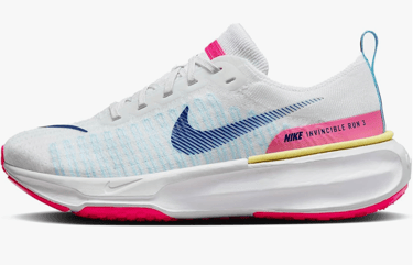 Nike Invincible 3 running shoe in bright mango and hyper pink colorway on pavement during outdoor wear test.