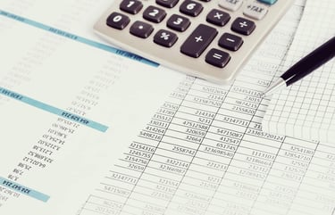 a calculator and pen on a paper with a pen and a pen