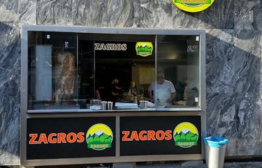 a restaurant with a large window and a sign that says  logo zagros gemüse kebap berlin