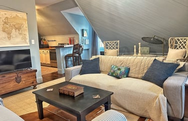 living room Upper Loft attic apartment lynchburg virginia. Large couch and kitchen.