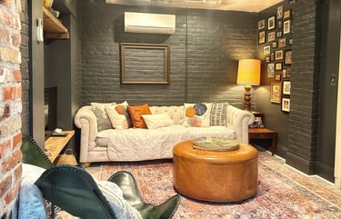 living room with white sofa and brick painted walls 