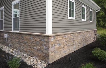 a house with a stone wall des moines