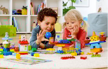 Colorful LEGO DUPLO bricks and gears from the STEAM Park kit built into a small, playful carousel.