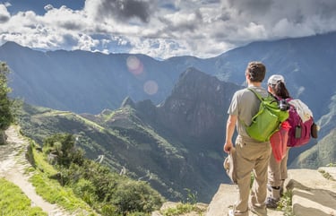 This image captures trekkers on the Inca Trail to Machu Picchu, Peru, admiring the breathtaking Andean landscape.