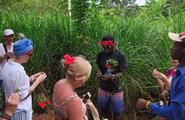 Tourist observing a local guide demonstrating spices at a Zanzibar spice farm during an authentic spice tour experience