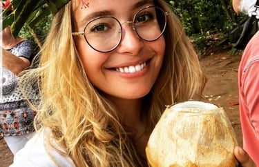 Tourist drinking fresh young coconut dafu at Zanzibar spice farm during guided spice tour with local expert