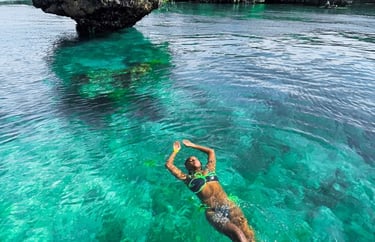 Tourist swimming in crystal-clear waters during Safari Blue Zanzibar boat tour, enjoying snorkeling and marine life adventure