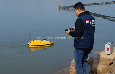 Seorang surveyor Indonesia mengenakan rompi kerja GeoNav Solution sedang mengoperasikan kapal batime