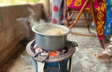 Traditional Zanzibari local food being cooked on a charcoal stove (jiko la mkaa) during a Zanzibar spice tour, showcasing