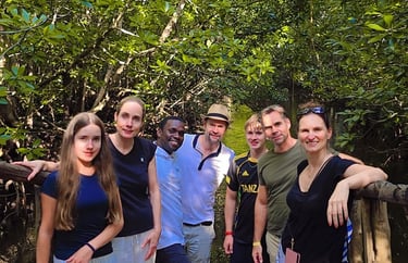 Group of tourists exploring Jozani Forest Zanzibar with a local tour guide during a wildlife and nature walk
