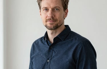 Professional portrait of a man in a dark blue shirt, minimalist and bright background, natural lighting, Northern European / Baltic / Estonian.