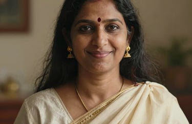 A portrait of a South Asian woman spiritual teacher, smiling gently. She wears gold earrings and a cream shawl. Warm, inviting natural light.