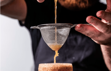 Professional mixologist preparing a handcrafted cocktail for a private event.