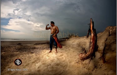 Shirtless barefoot man flexing on beach with jeans and plaid shirt, driftwood, ocean, cloudy sky.