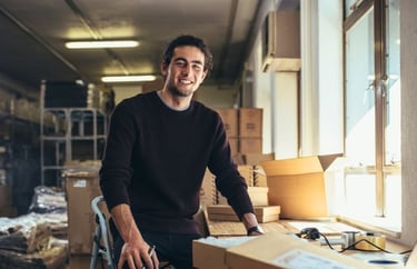 A man standing in a room with boxes of boxes