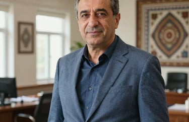Professional portrait of Ömer Hoca, a middle-aged man with a supportive expression, in a modern academic office with Anatolian design touches, slate blue blazer, natural lighting.