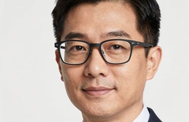 A professional headshot of a person wearing modern stylish glasses and business attire, clean white background, North American professional style.