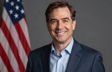 Professional studio portrait of a foundation leader, North American / US style, wearing professional attire with a warm, trustworthy expression.