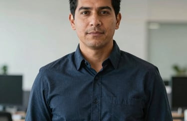 Portrait of a male South American logistics coordinator looking organized and capable, wearing a smart-casual outfit in a professional setting.