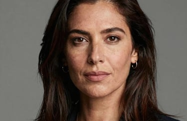 Professional headshot of a female South American creative director with an artistic and professional appearance, neutral studio background.