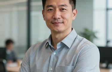 A professional portrait of a male operations director in a North American corporate office, looking towards the camera with a confident and helpful expression.