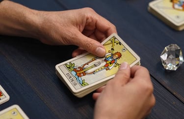 A close-up photography of a professional tarot reader's hands holding a deck of cards over a dark navy wooden table. The lighting is focused and warm, highlighting the intricate details of the cards and a small crystal prism. Northern European setting.