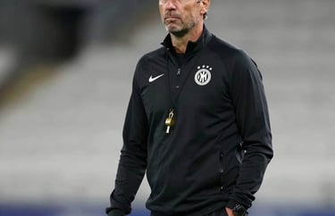 Portrait of a professional European soccer coach in his 40s, wearing a black training tracksuit with a gold whistle. Modern stadium background, soft professional lighting.