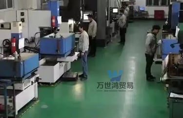 Technicians operating CNC machinery on a modern factory floor for precision industrial manufacturing.