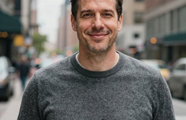 A professional portrait of a man in a professional grey sweater, appearing trustworthy and welcoming, North American urban backdrop.