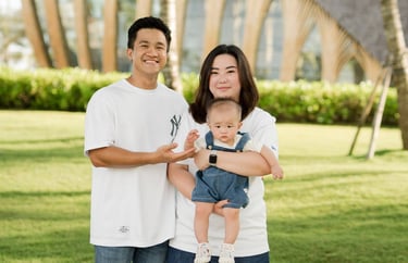 Family portrait standing together on the lawn at The Apurva Kempinski Nusa Dua Bali