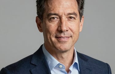 Professional headshot of a mid-40s North American man in a navy blazer. Clean background, sharp focus, projecting expertise and trust.