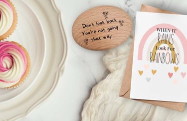 a card with a rainbow and a positivity pebble