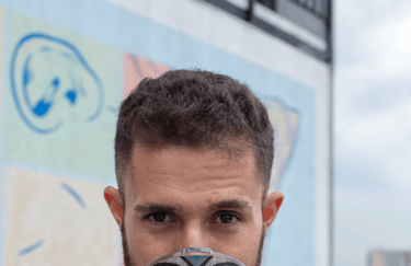 a man with a beard and a mug of coffee